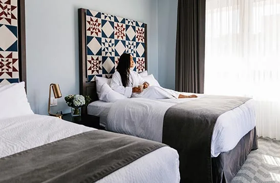 A guest room bed at Mount Royal Hotel.