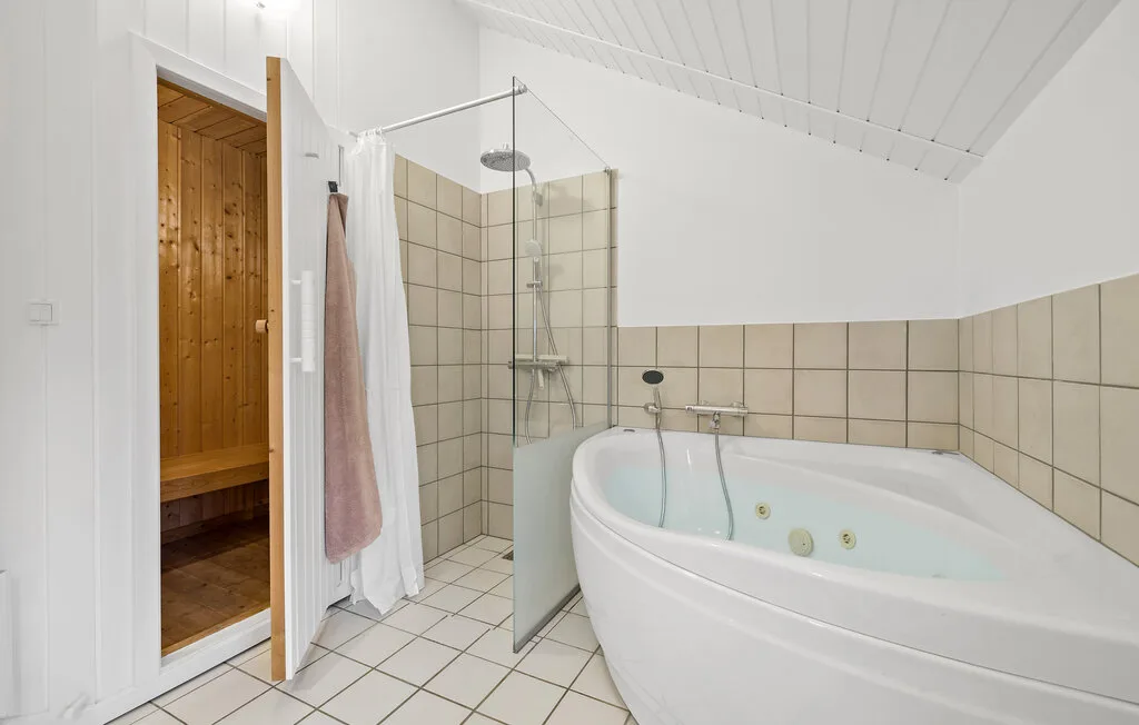 A bright bathroom with a corner shower and a large bathtub.