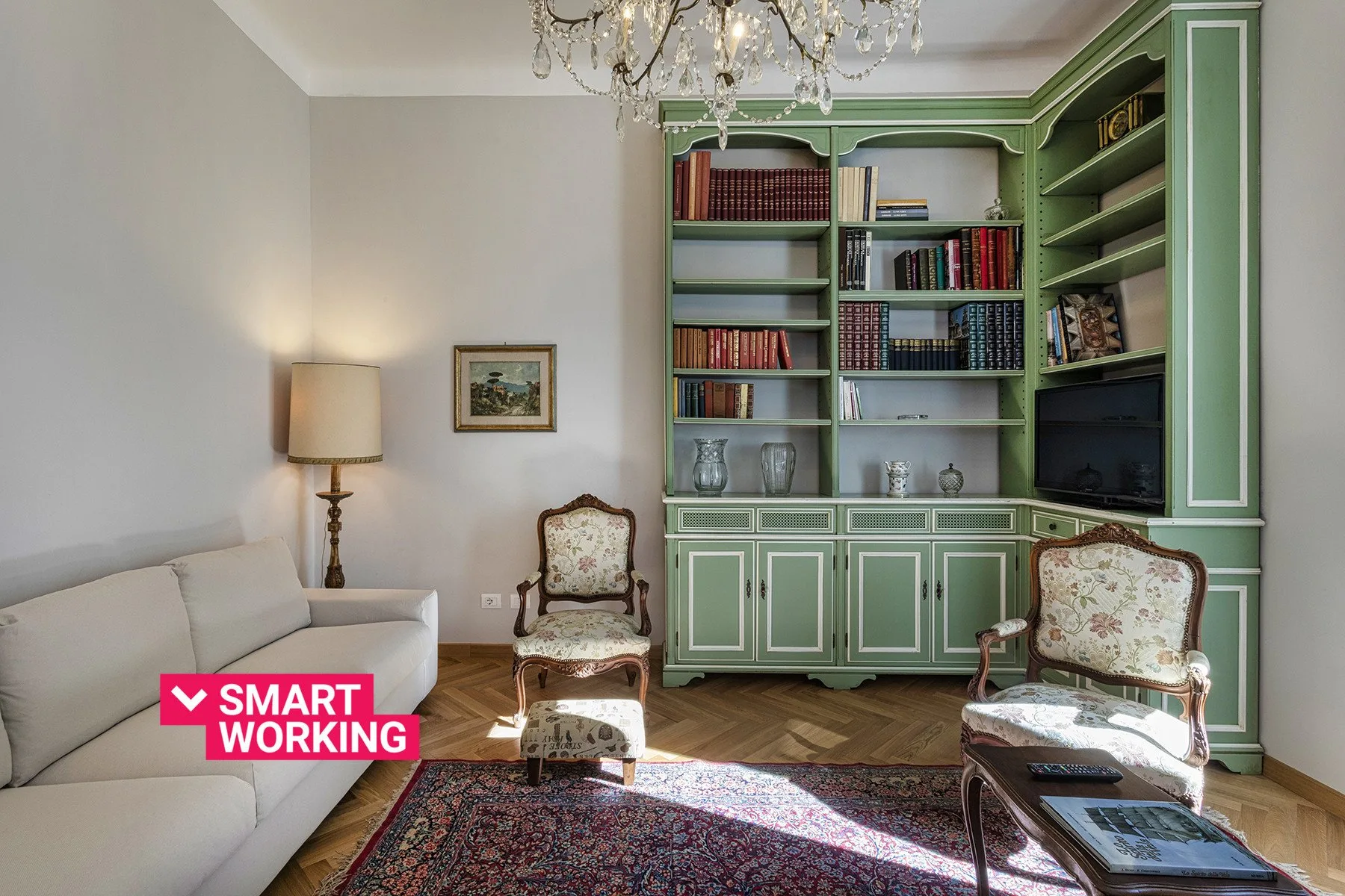 A living room with green built-in bookshelves and upholstered seating.