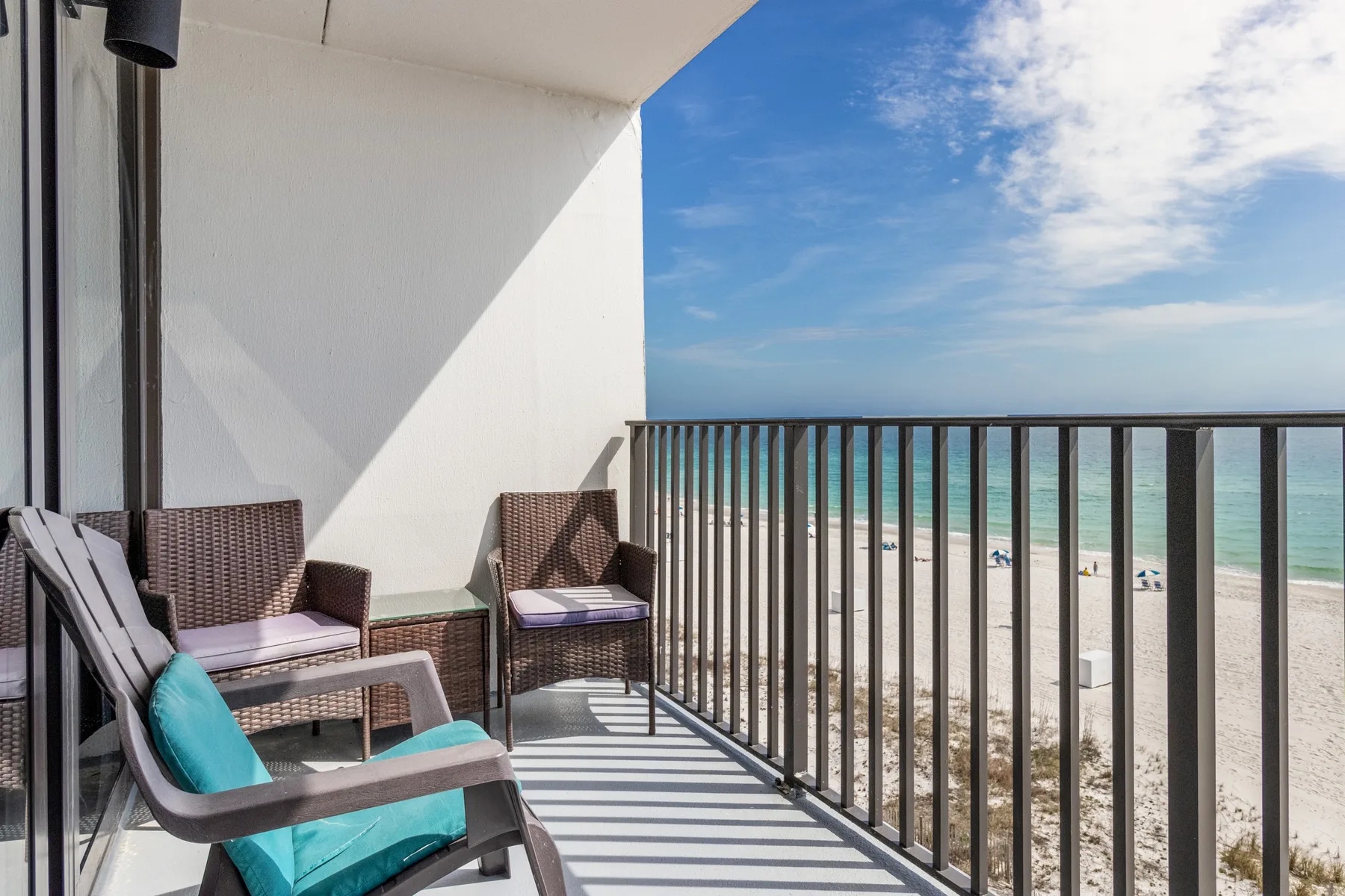 A balcony seating area overlooks the beach and ocean.
