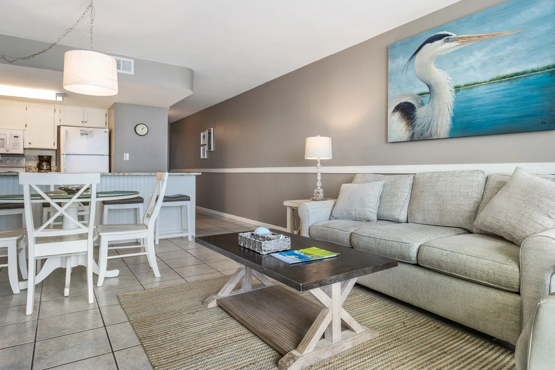 A living and dining area with a light-colored sofa and a dining table.