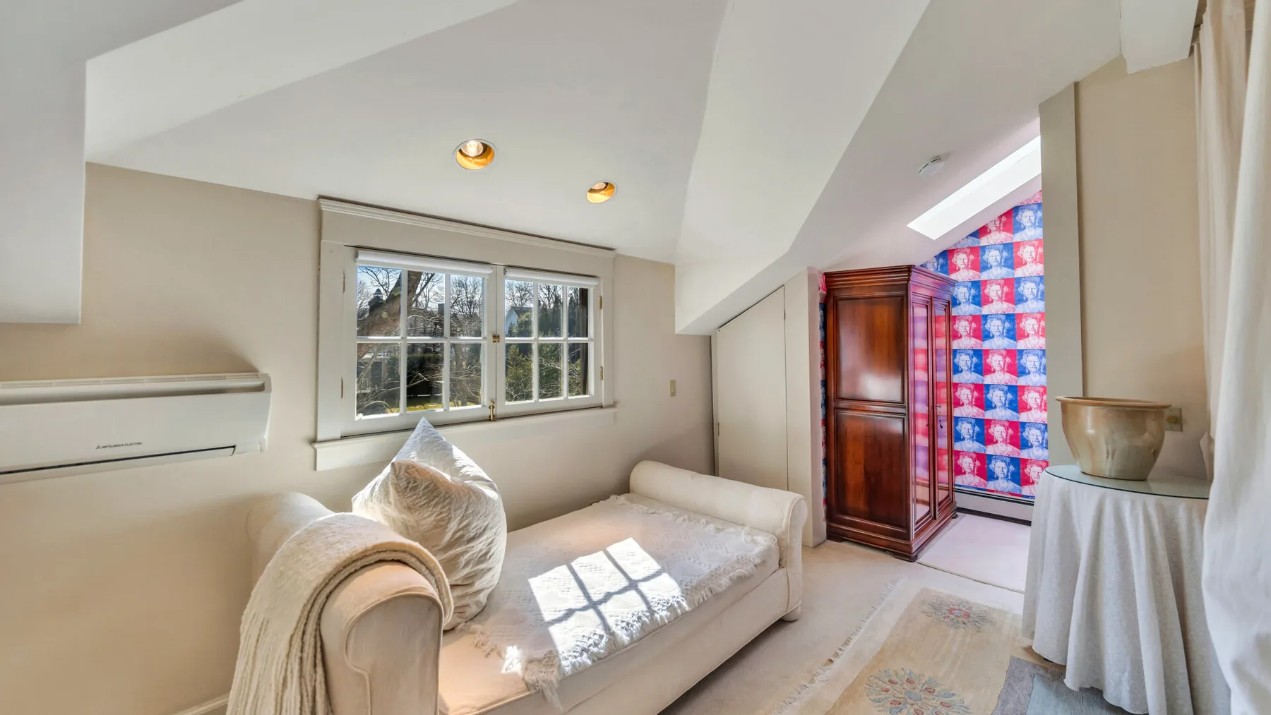 A bright living room with a sofa beside a window.