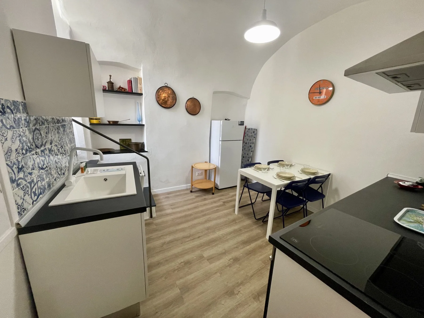 A kitchen and dining area with a table, chairs, and cooking counters.