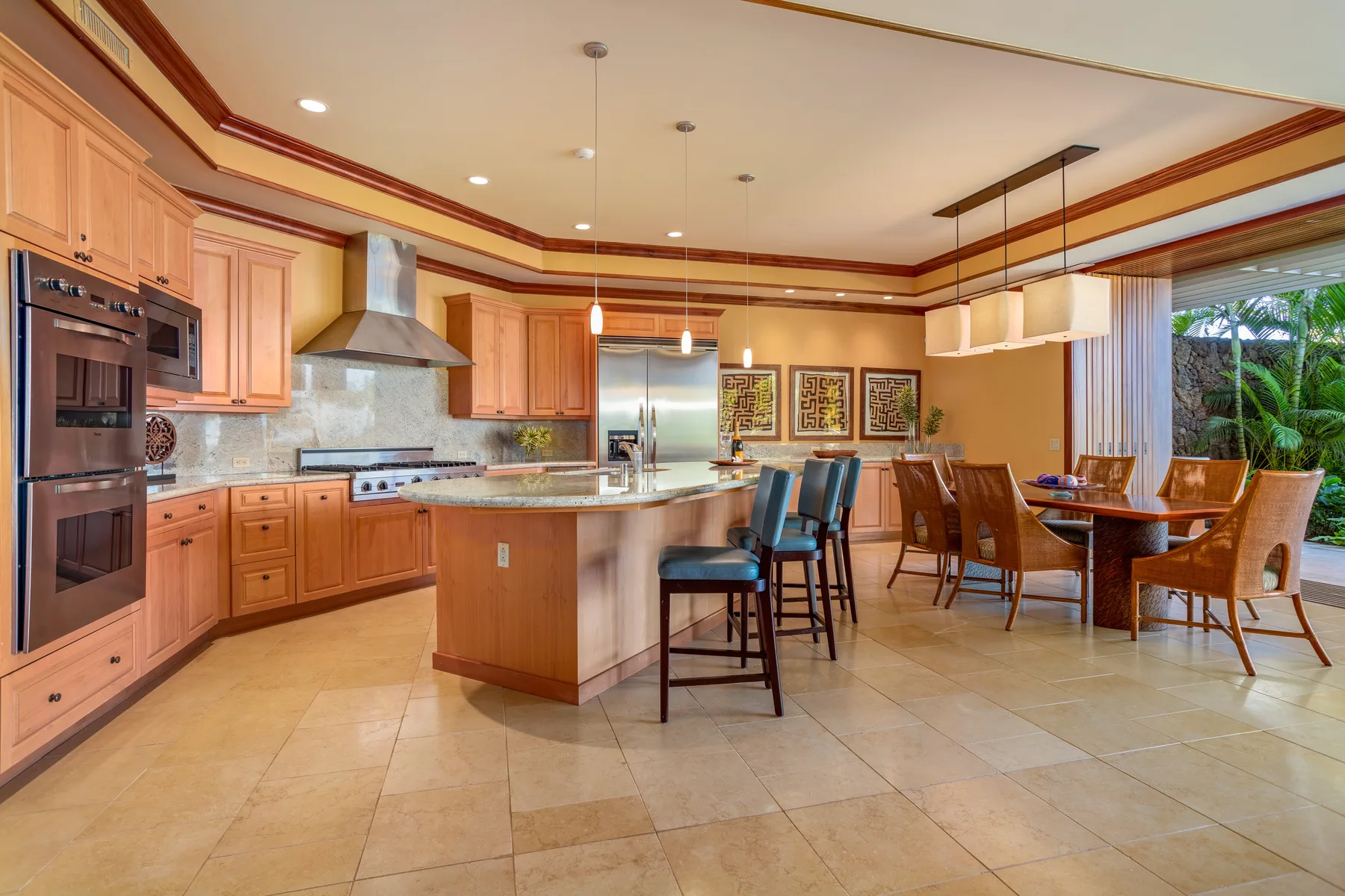 A spacious kitchen with a central island and dining area.