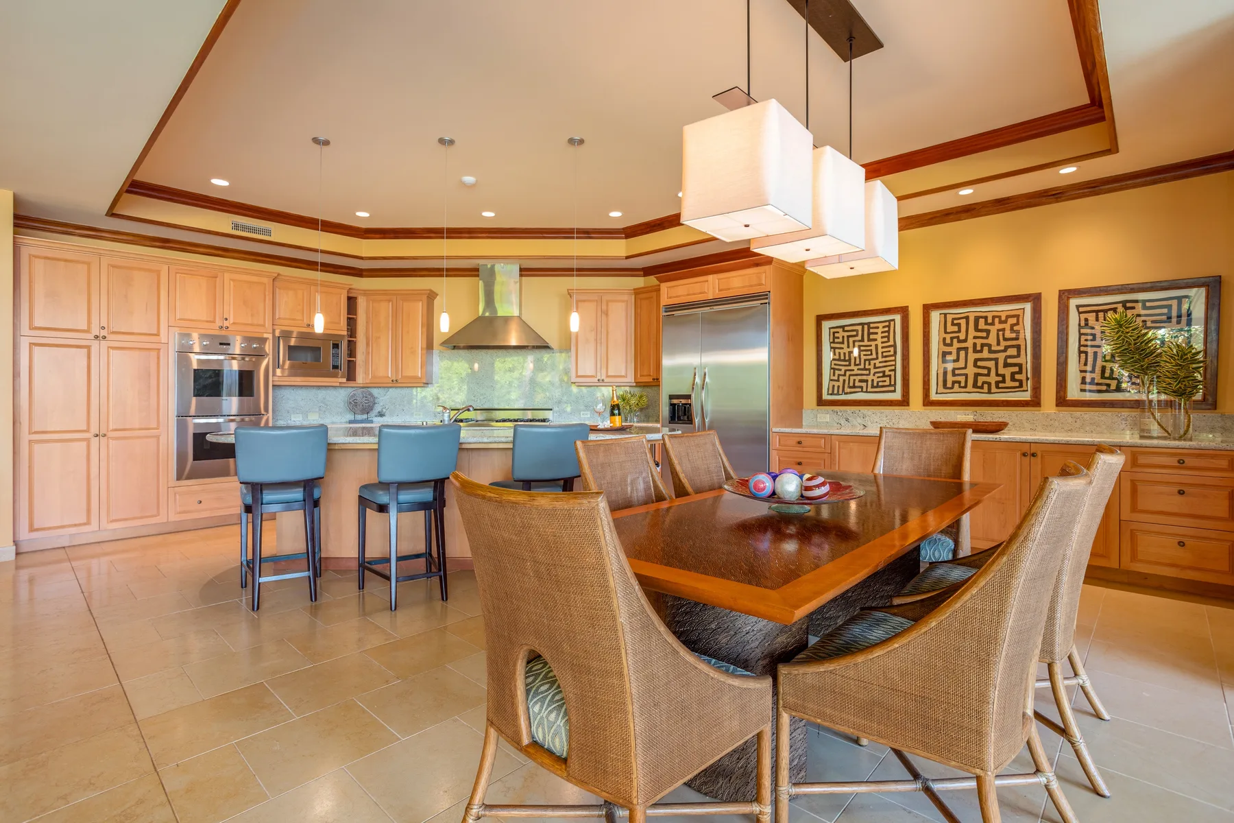 A spacious kitchen and dining area features a wood table and island seating.