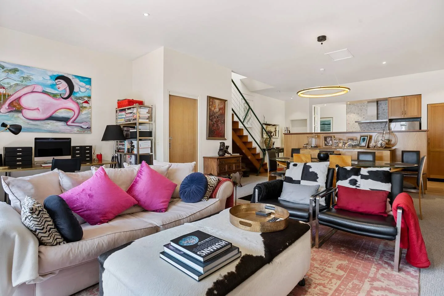 Sala de estar con muebles de estilo retro, sofá, sillones de cuero y televisión.
