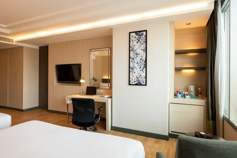 Kitchen in room with two double beds.