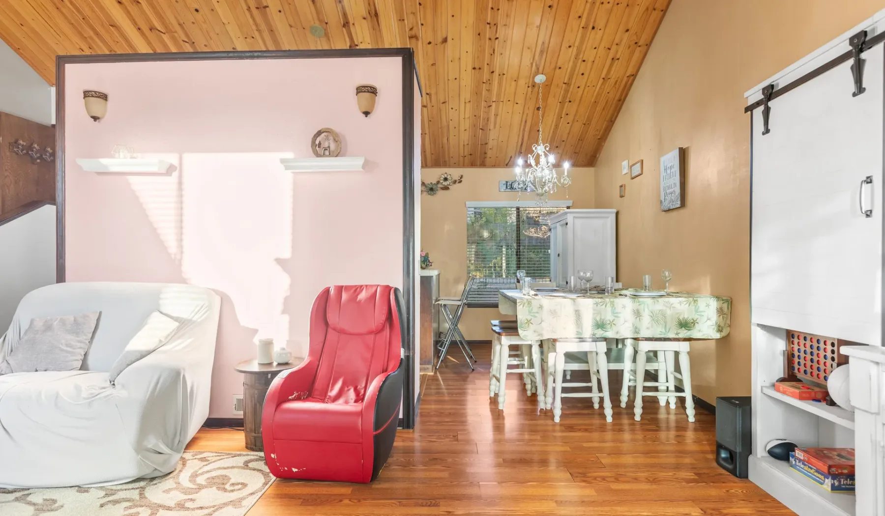 An open living and dining area with a red recliner and a table.