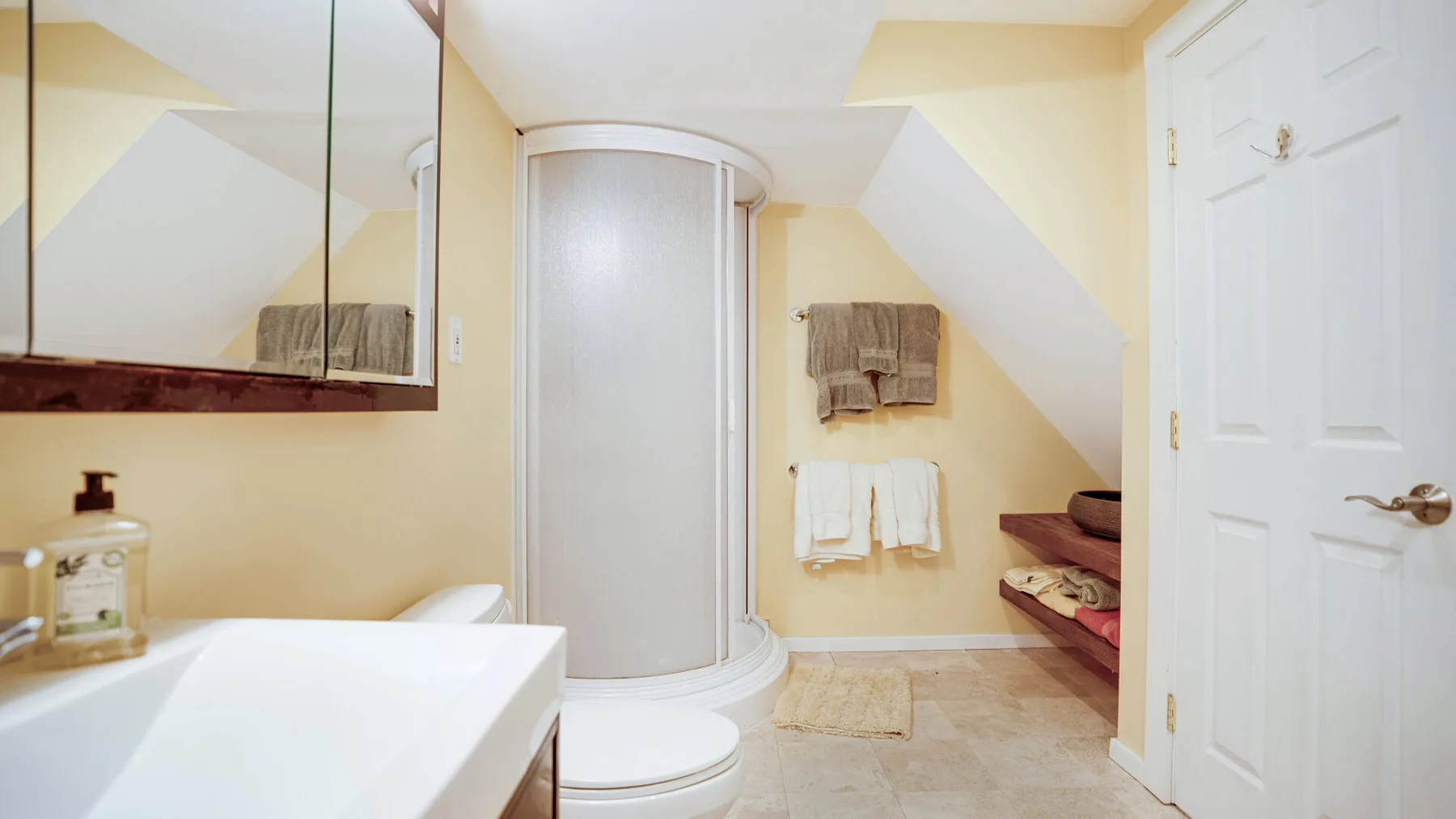 Un baño con una ducha curva, lavabo e inodoro.