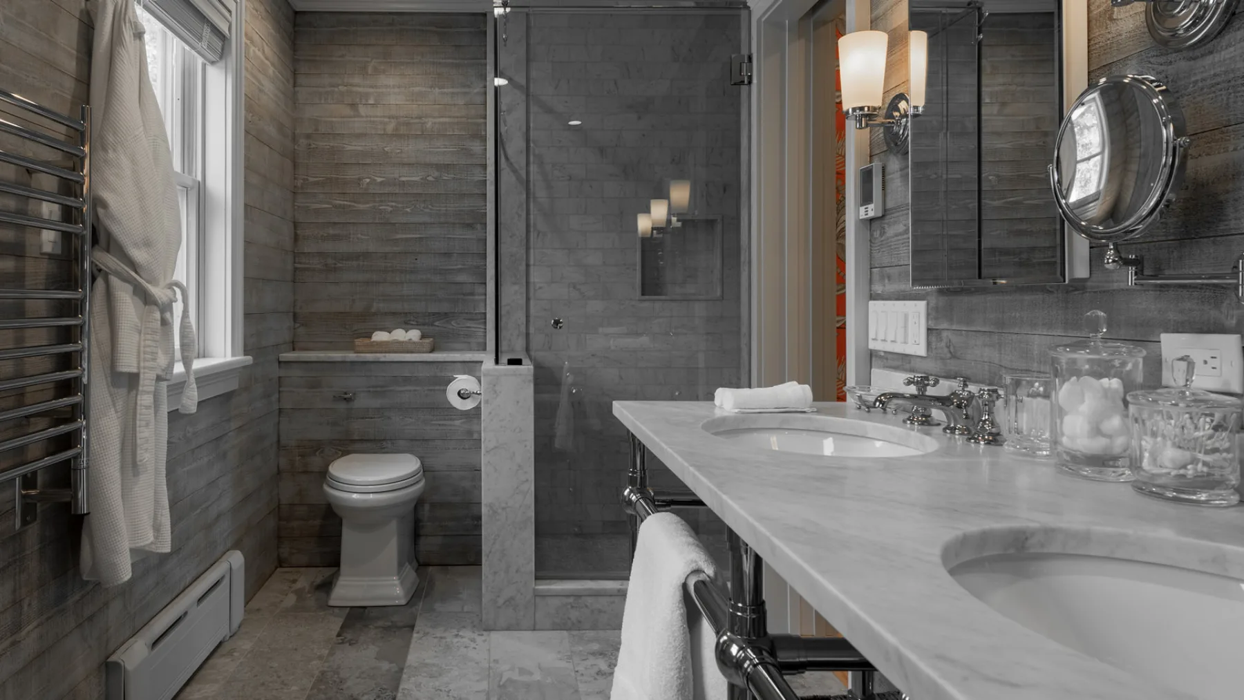 A bathroom with a long vanity, mirror, and glass shower.