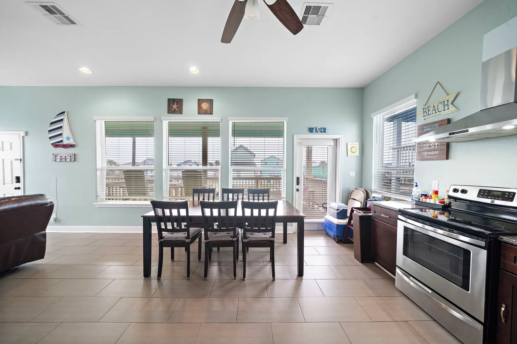 A dining area with a table and chairs beside a kitchen.