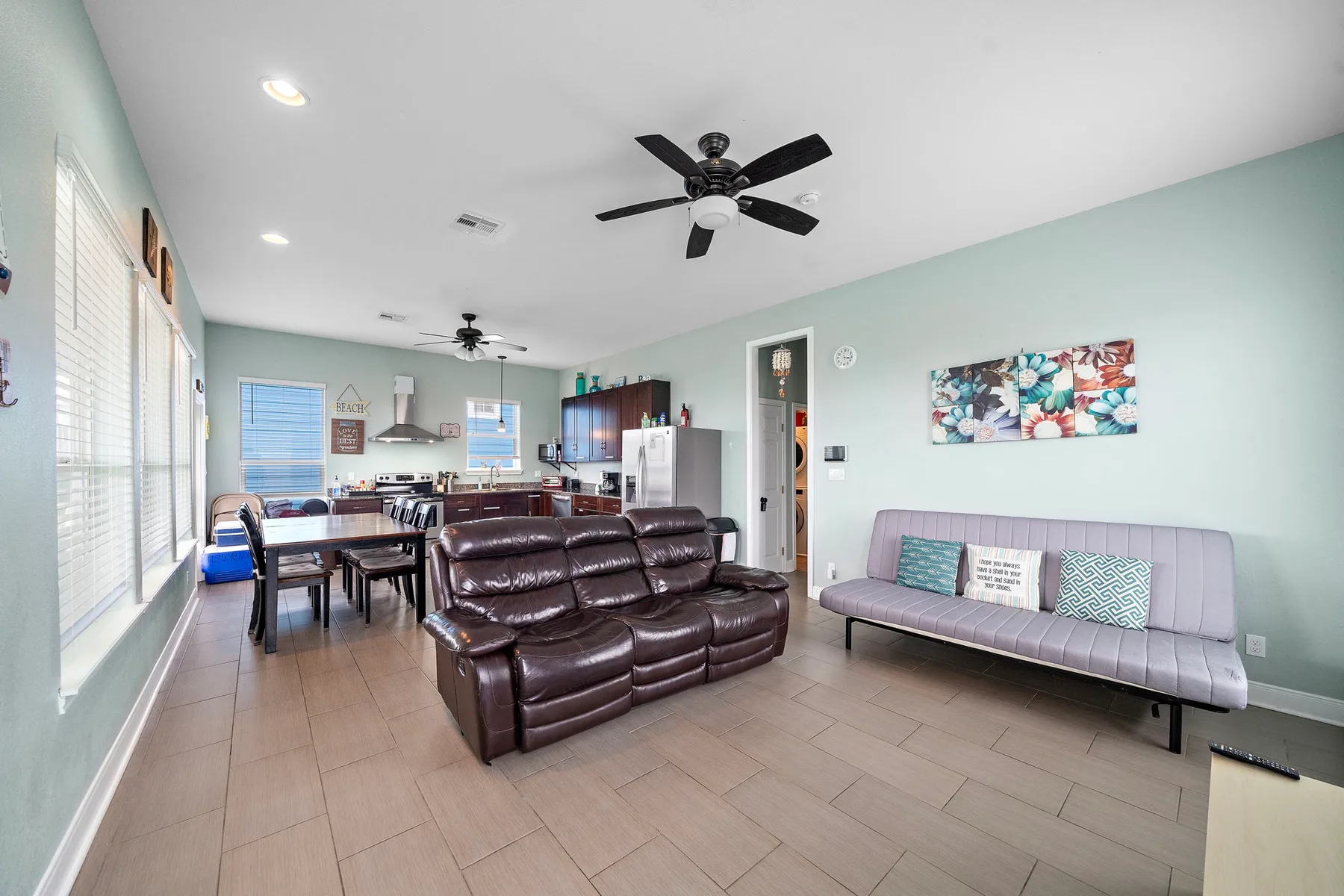 Open living and dining area with dark seating and a dining table.