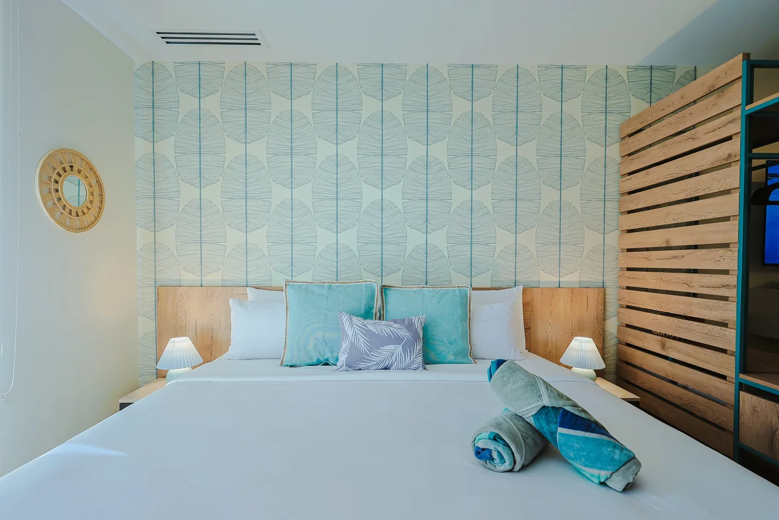 Sink into your coastal-inspired retreat, where natural wood, soothing turquoise accents, and fresh linens create a tranquil haven. Your peaceful escape awaits, perfectly designed for rest and relaxation.