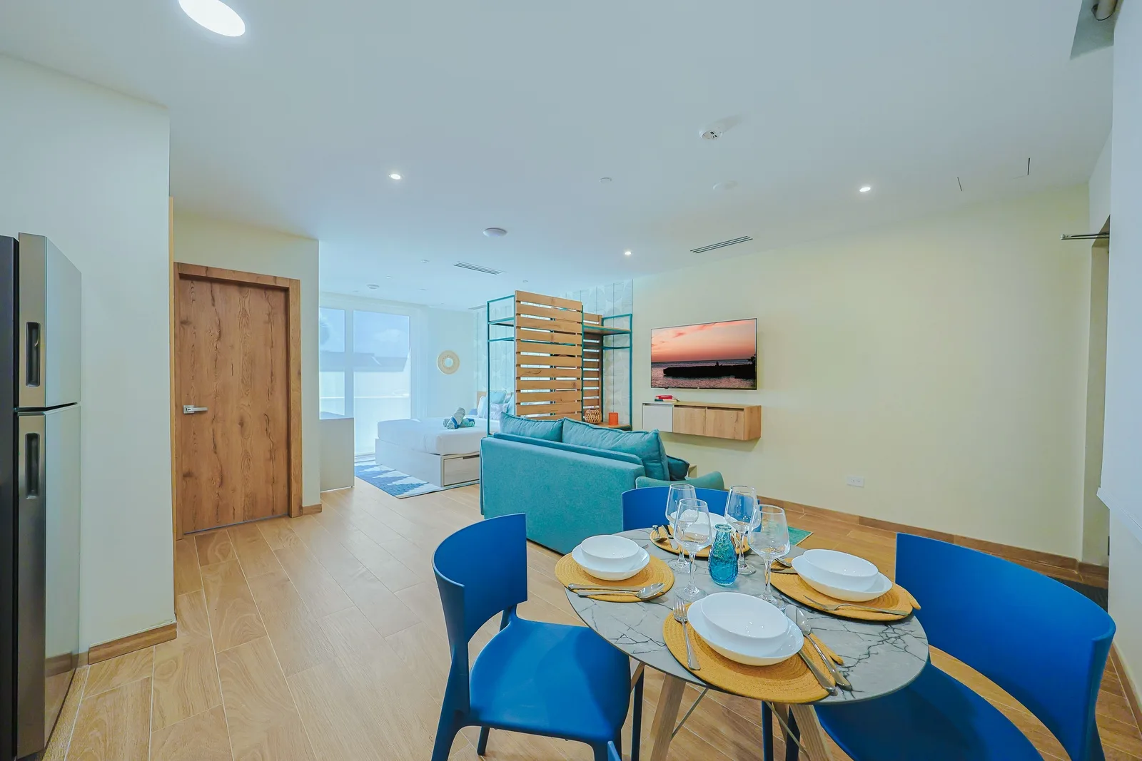 Enjoy a light-filled open-concept living room featuring comfortable seating, a dining area, and smart TV.