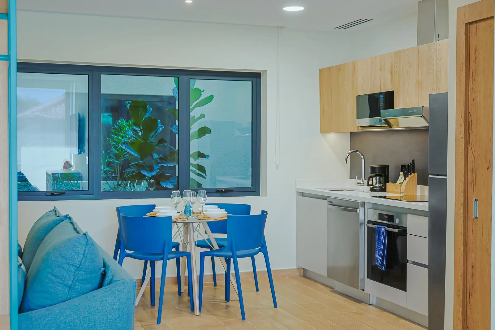 Step into your bright, modern kitchen and dining area—a welcoming space designed for shared meals and coastal living. Natural light pours in, while sleek appliances and cheerful seating make every moment feel effortless.