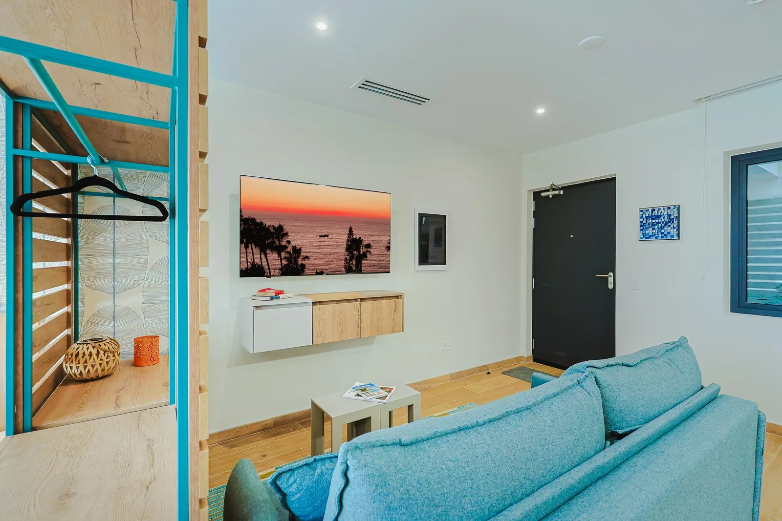 Unwind on your plush turquoise sofa while soaking in coastal vibes from the sun-drenched airy atmosphere. Modern design meets comfort in your bright, airy living space with sleek wood accents and climate control.