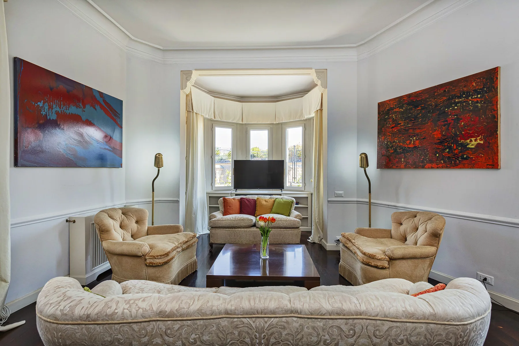 A bright living room with arranged seating around a low coffee table.
