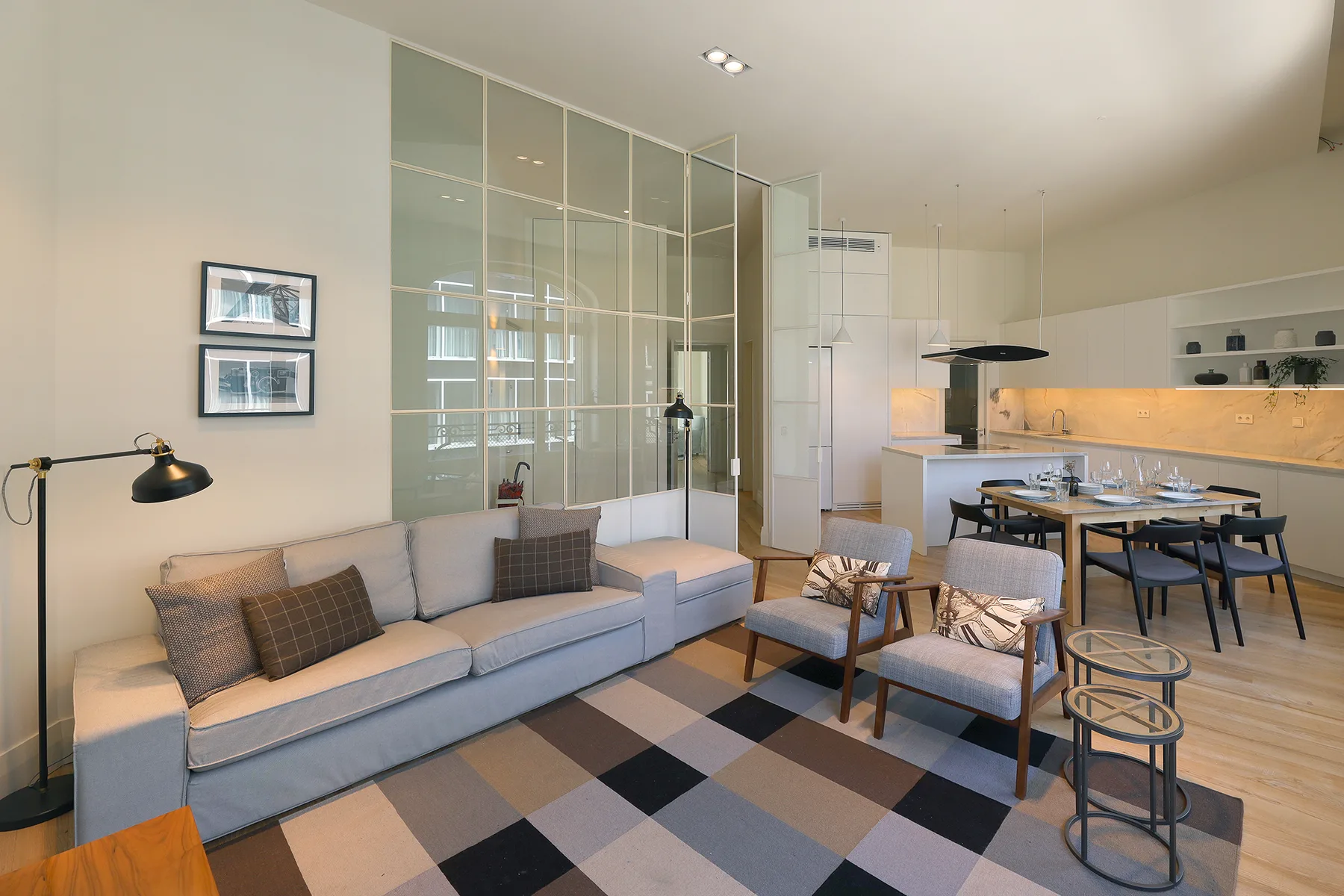 Living room with seating, a coffee table, and a dining area.
