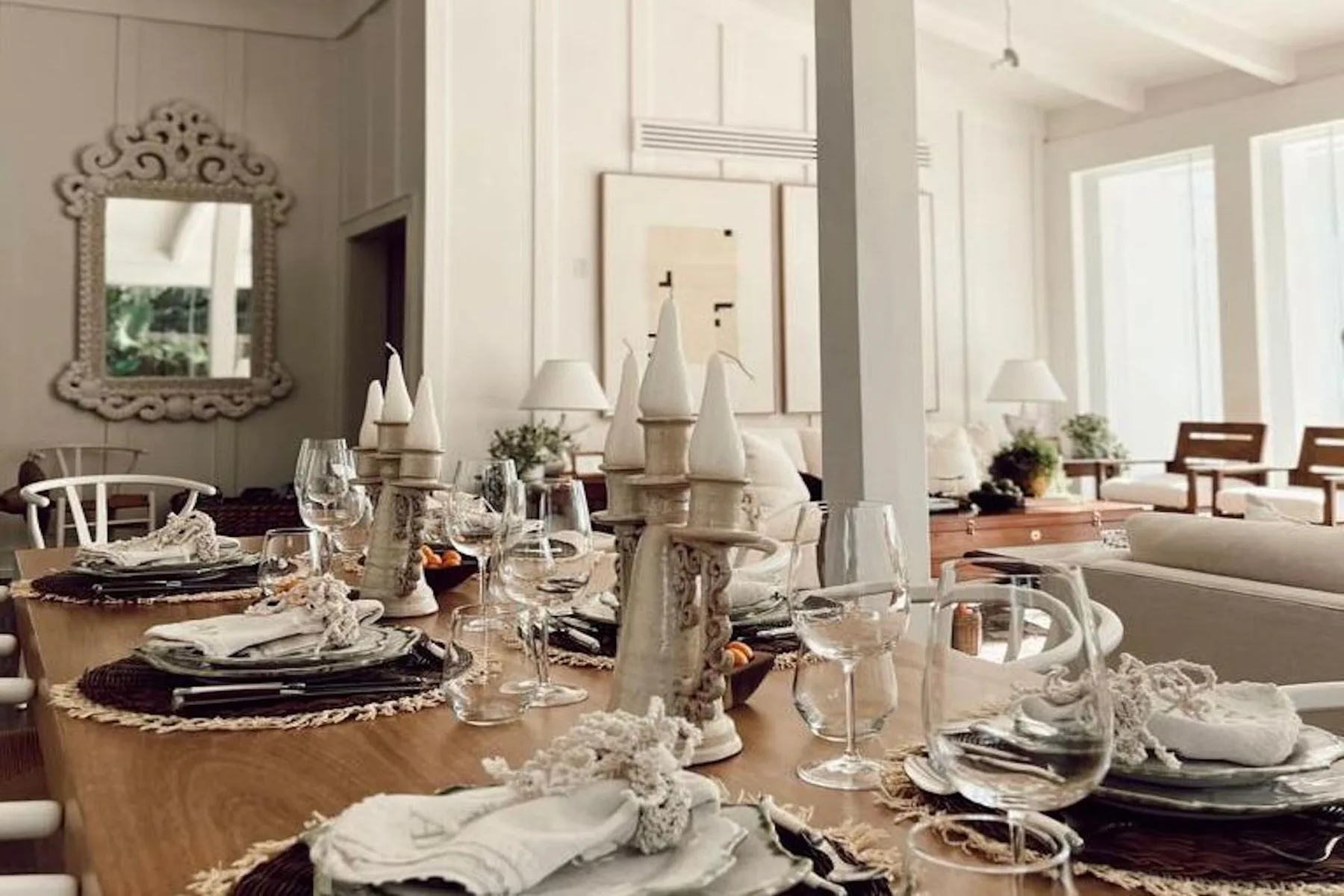 A bright dining room with a set table and large windows.