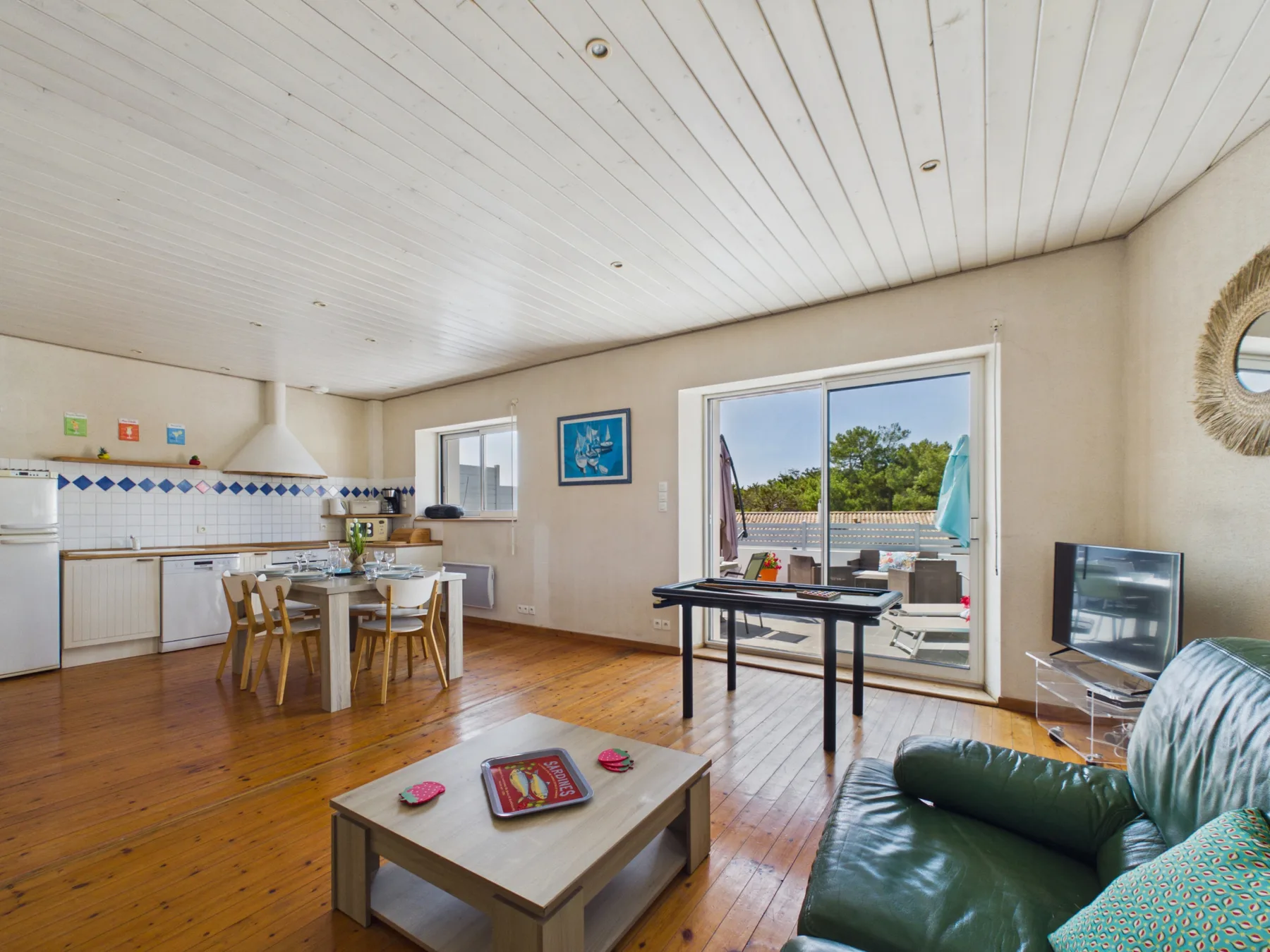 A combined living and dining area opens onto a patio through sliding glass doors.