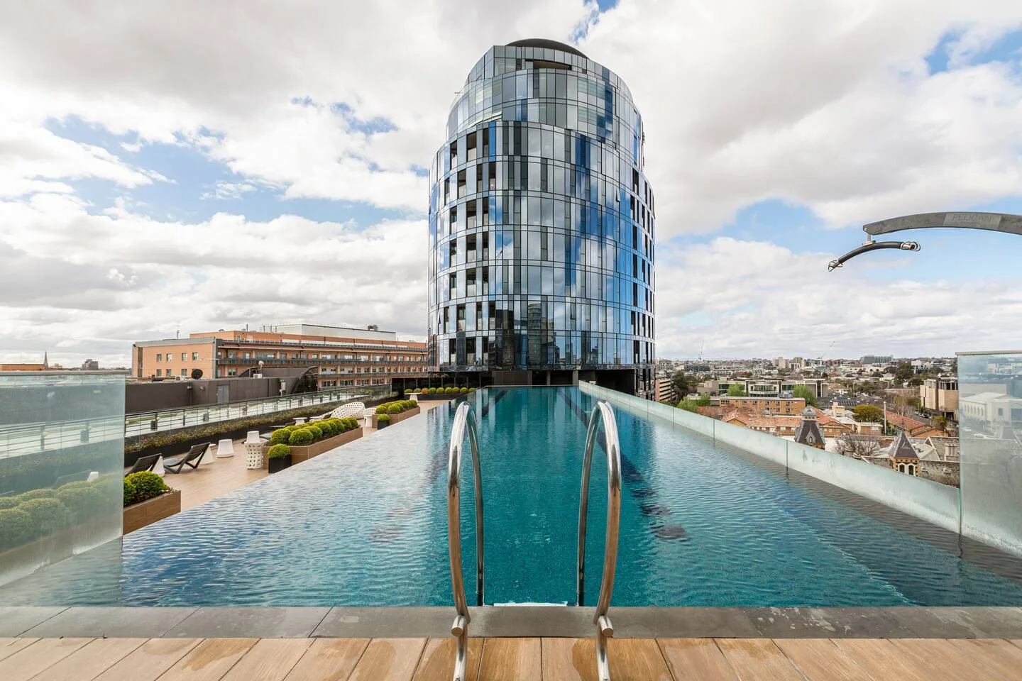 Swim above the skyline in the shared infinity pool, where open skies and city views create the perfect rooftop escape.