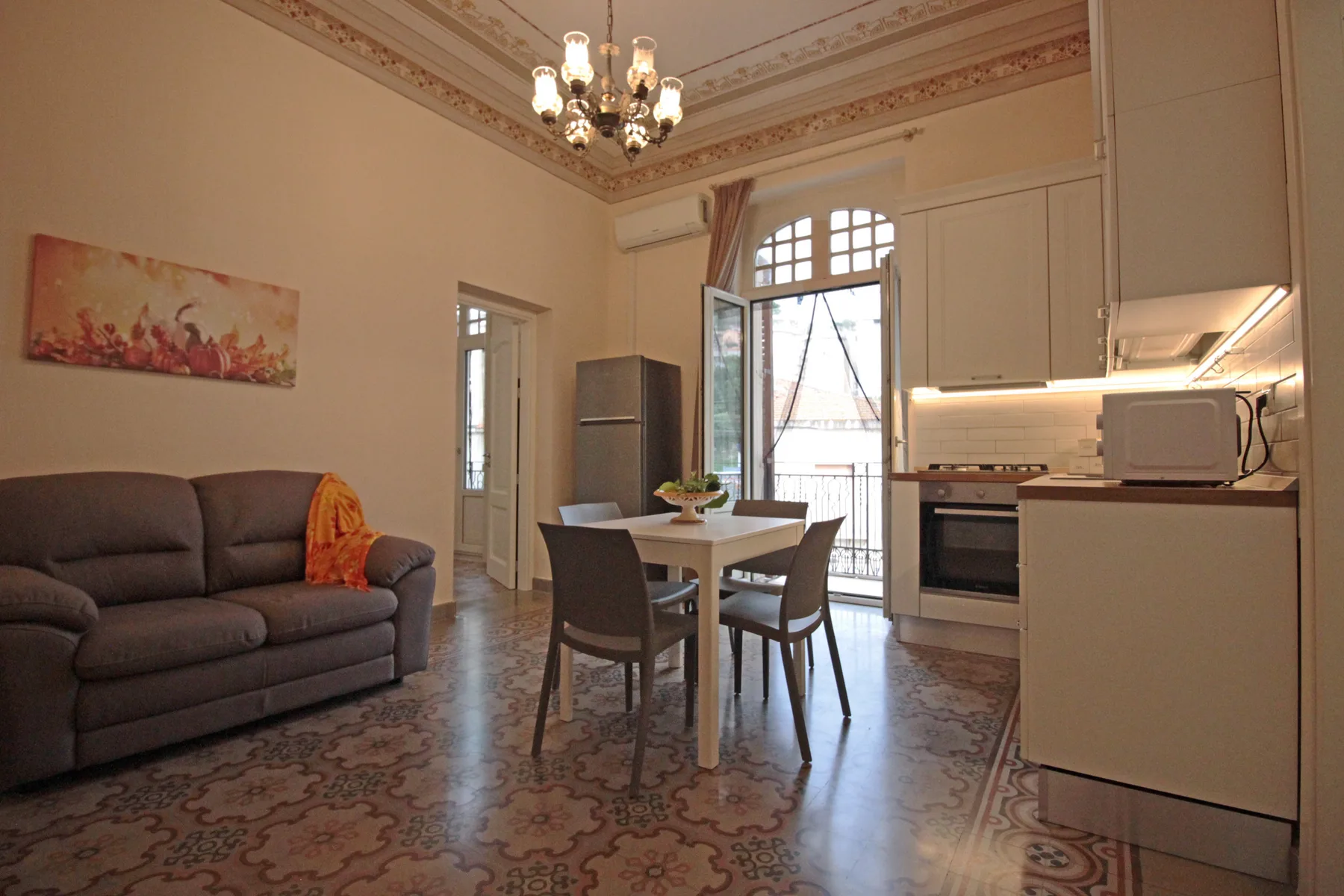 A dining area beside a compact kitchen, with a table and seating.