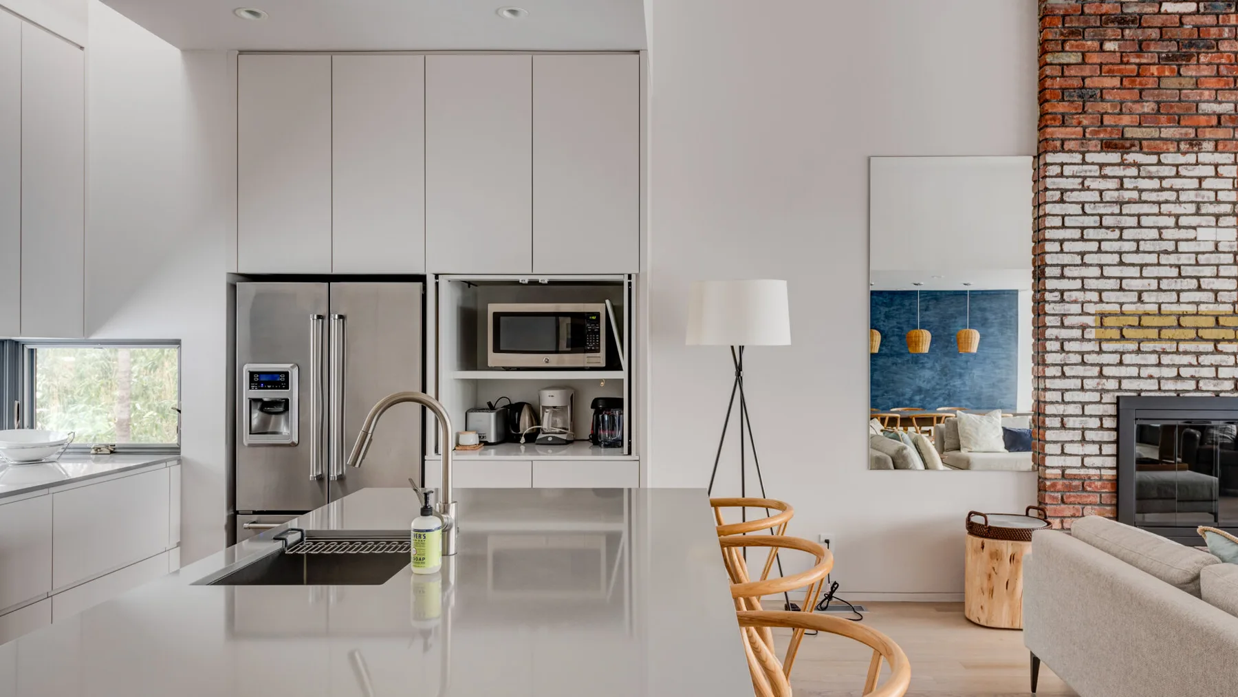 A modern kitchen with a central island and stainless steel appliances.
