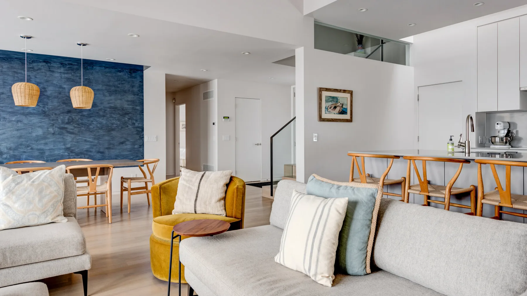 A bright open-plan living and dining area with a kitchen counter.