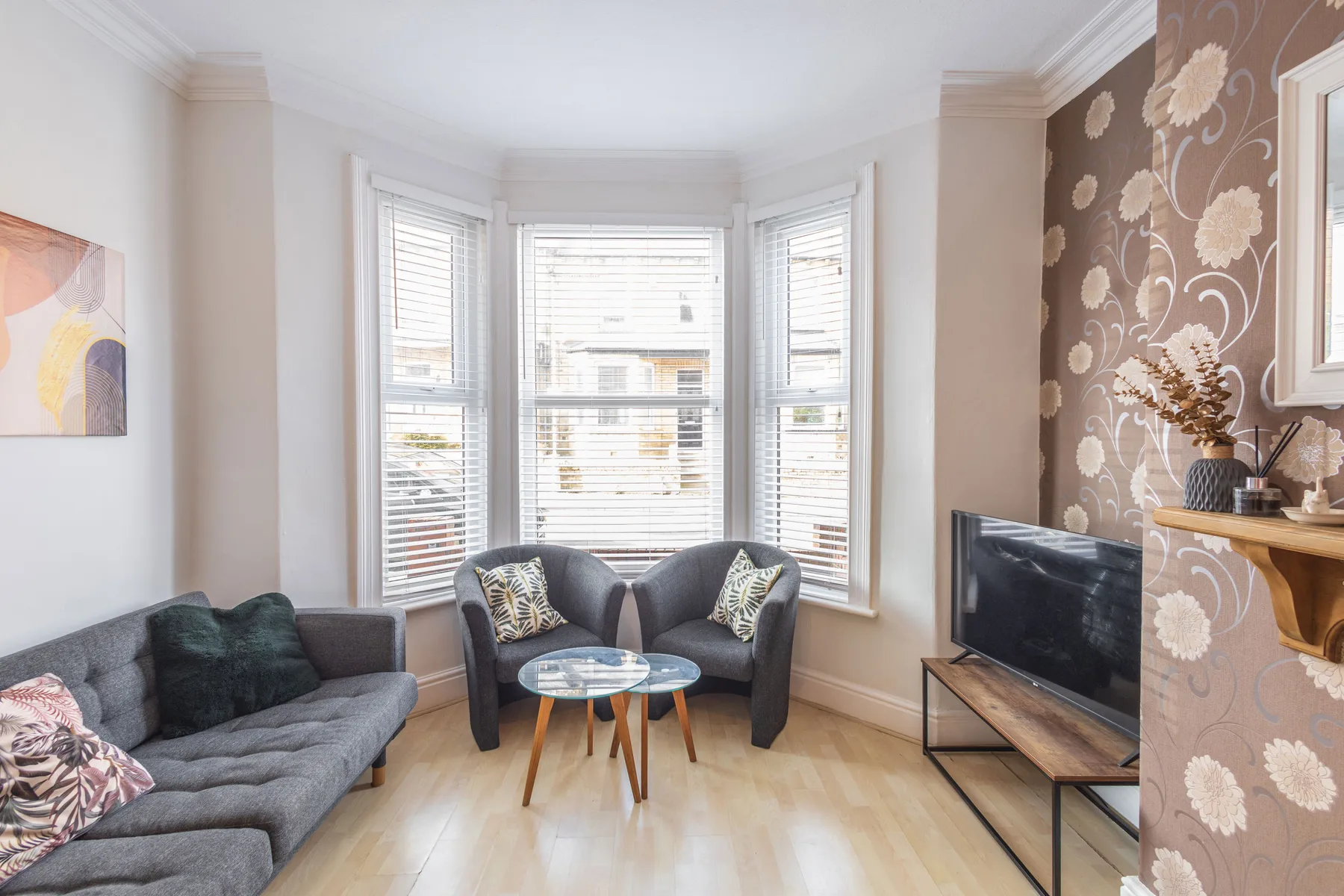 A bright living room with seating arranged around a small coffee table.