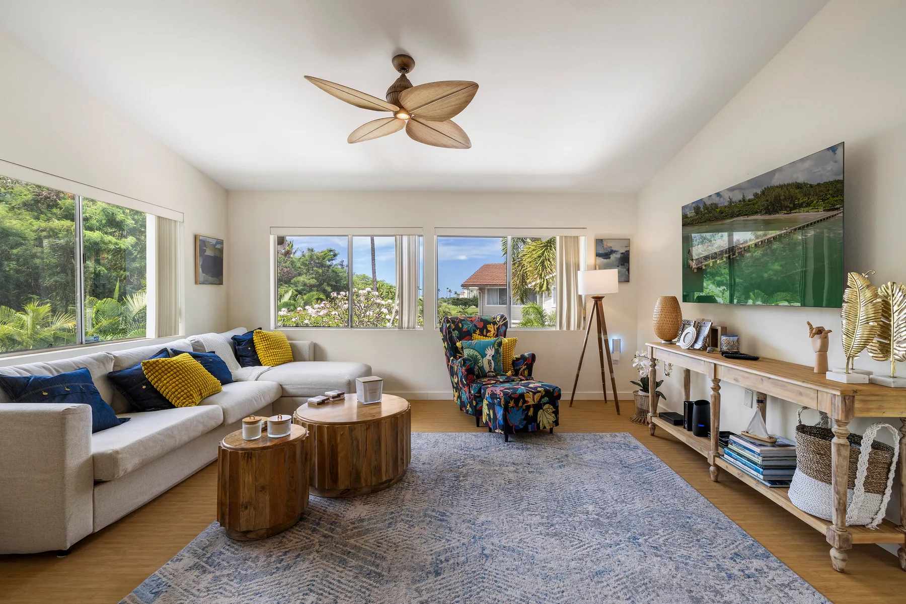 A bright living room with a sectional seating area and large windows.