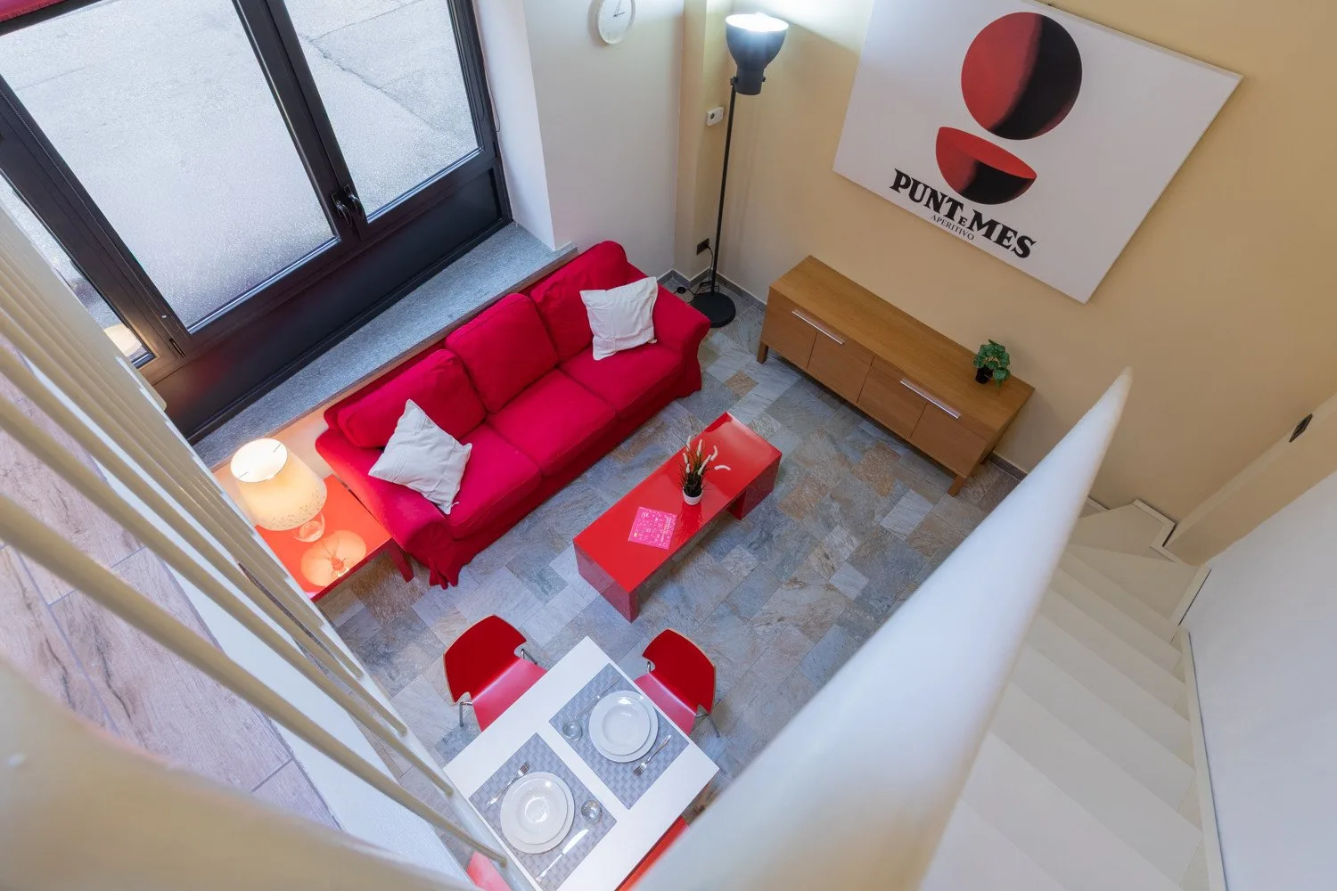 A living room with bright red seating and a low coffee table.