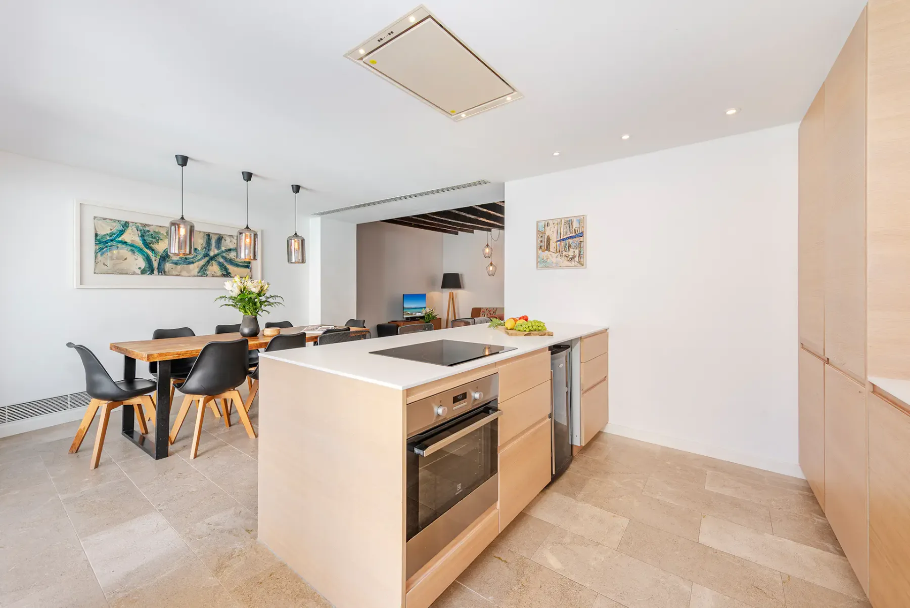 An open-plan kitchen and dining area with a central island and dining table.