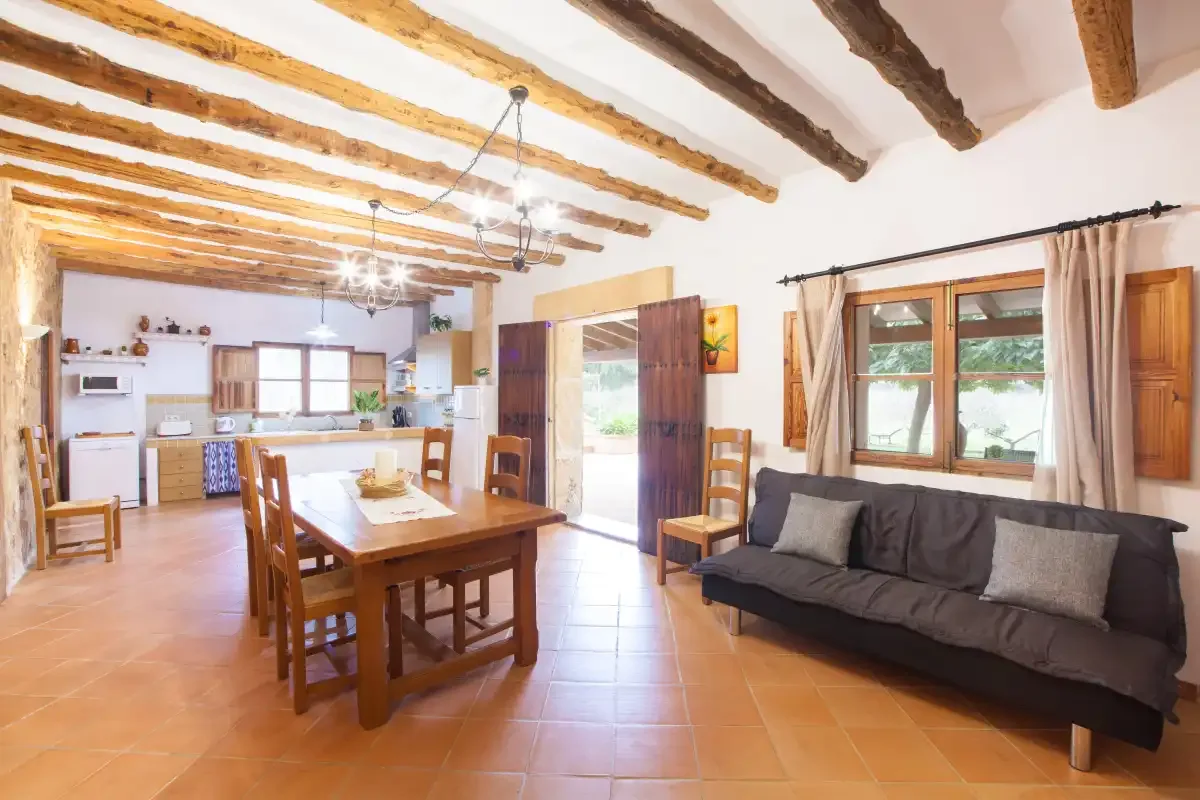 A dining and living area with a wooden table and seating.