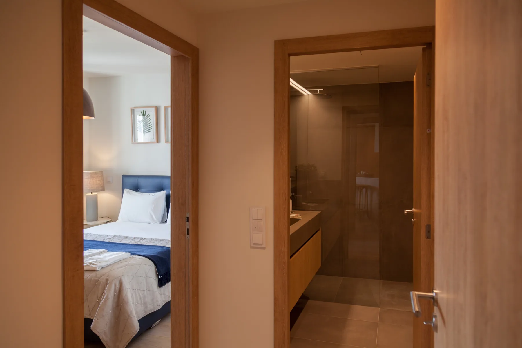 A bedroom and bathroom are visible through separate doorways.