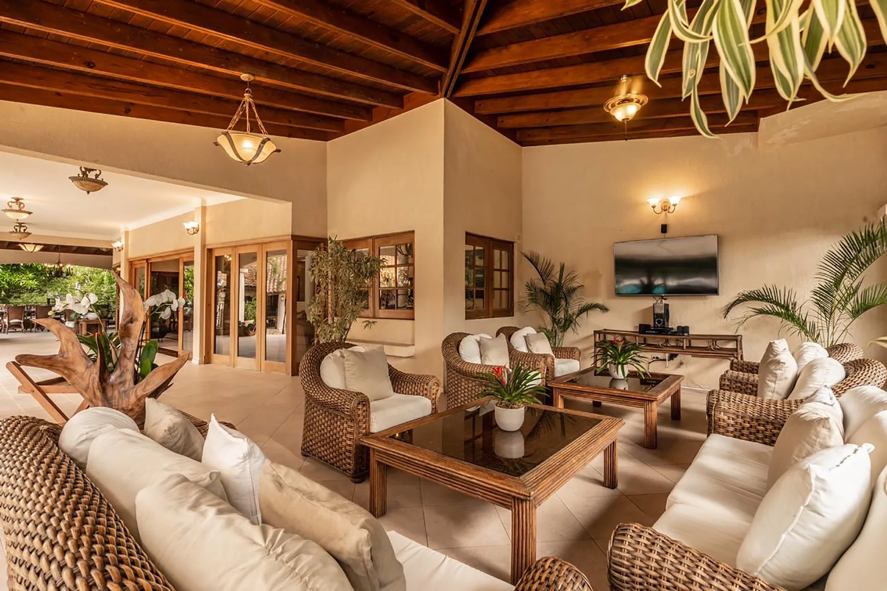 A spacious living room with wicker seating arranged around a low coffee table.