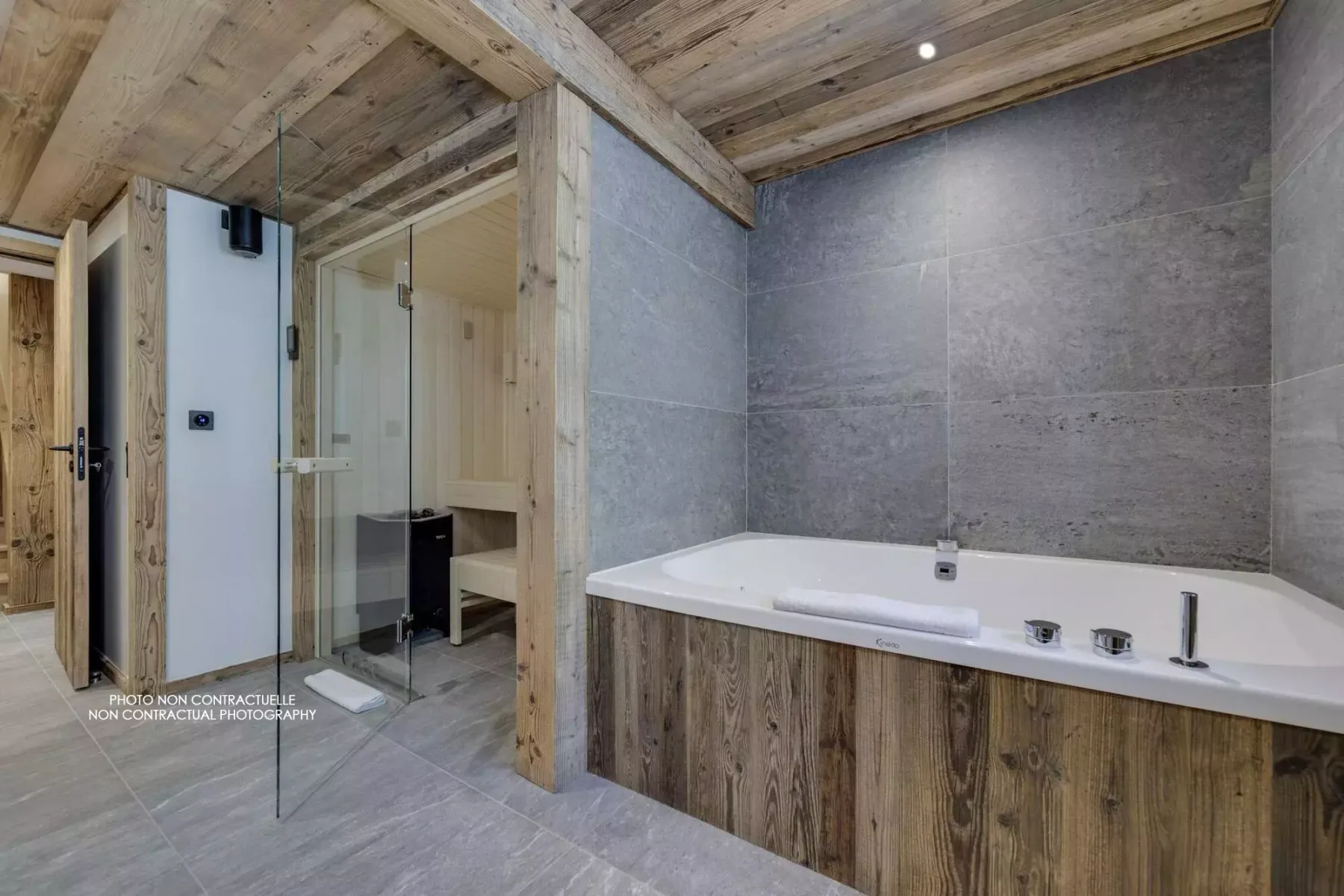 A bathroom with a bathtub beside a glass shower enclosure.
