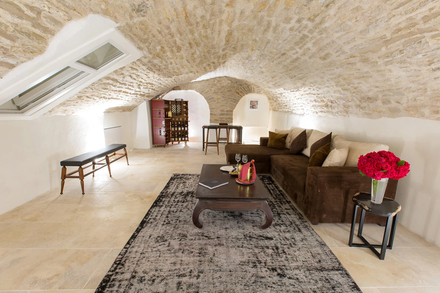 Lounge with a sofa and coffee table in a vaulted stone interior