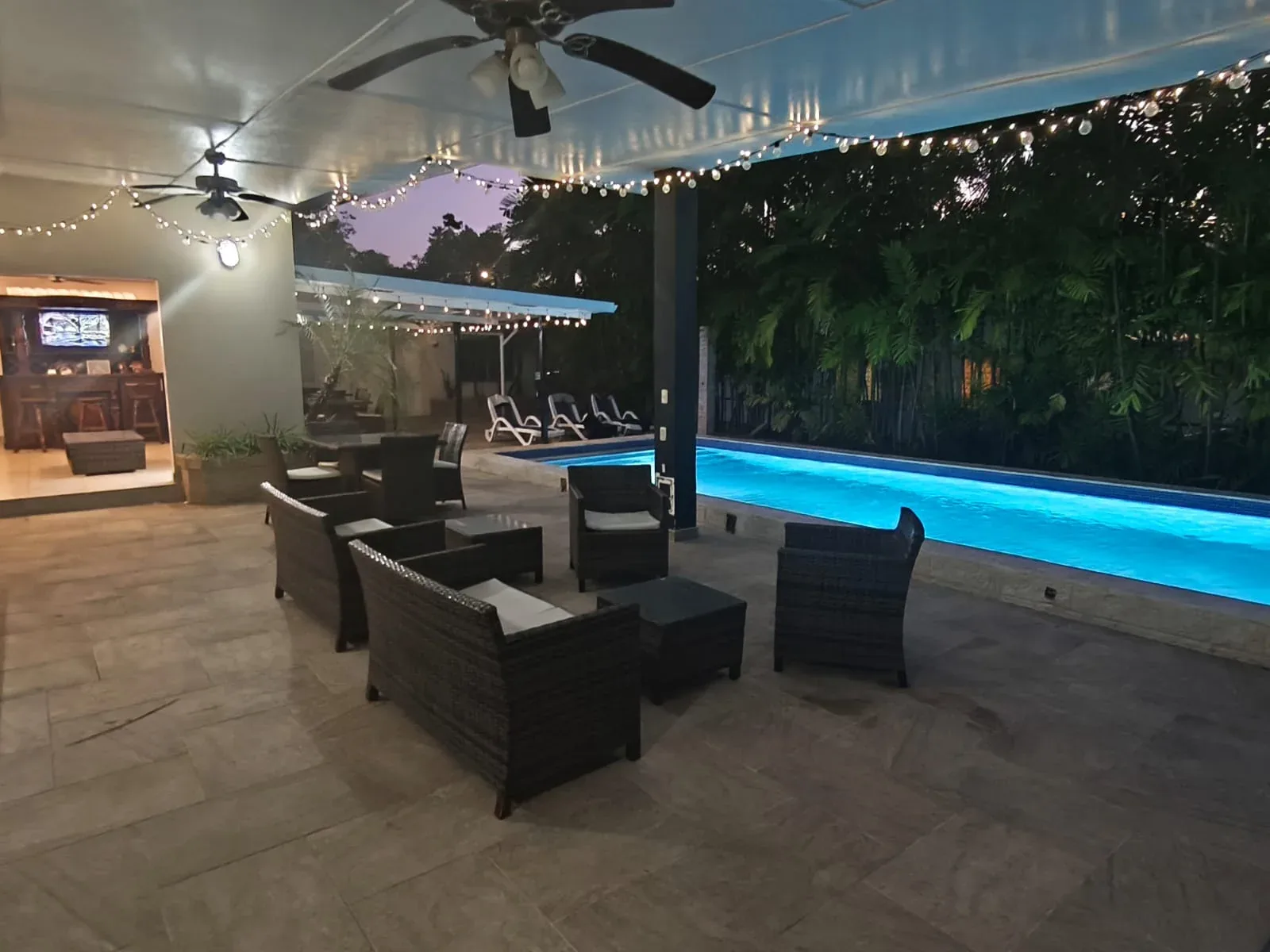 Lounge area beside the pool at night