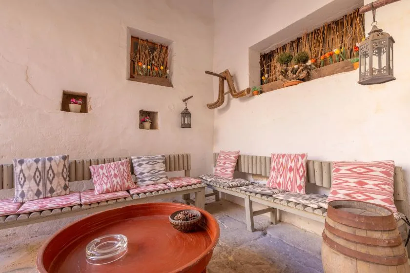 A cozy sitting area with patterned cushions and a low round table.