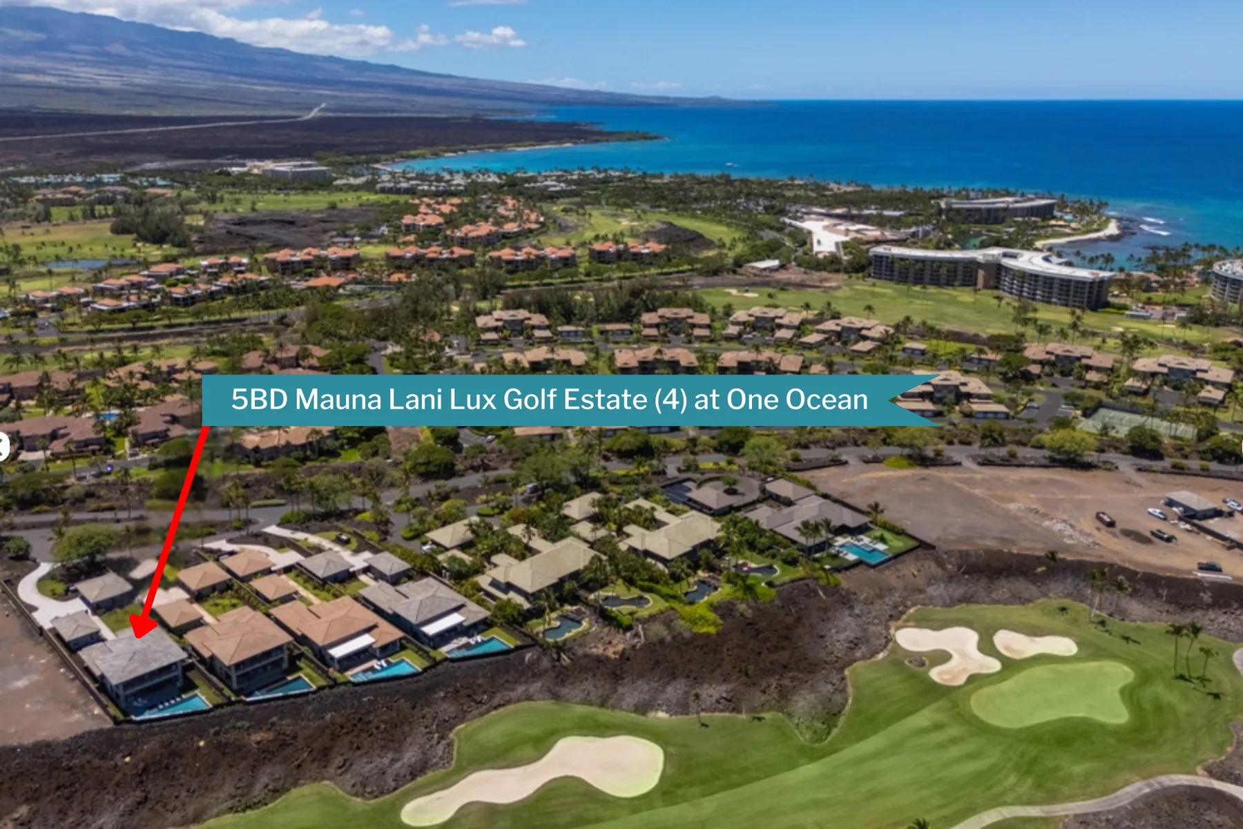 Aerial view of a coastal golf course and nearby homes.
