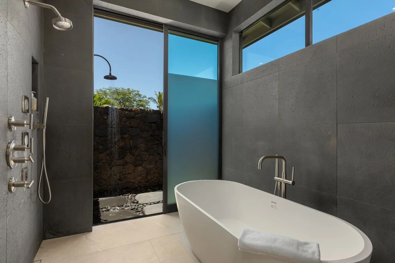 A modern bathroom with a freestanding bathtub and shower.