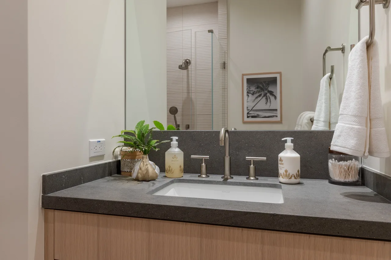 A bathroom vanity with a wide sink and a mirror above the counter.