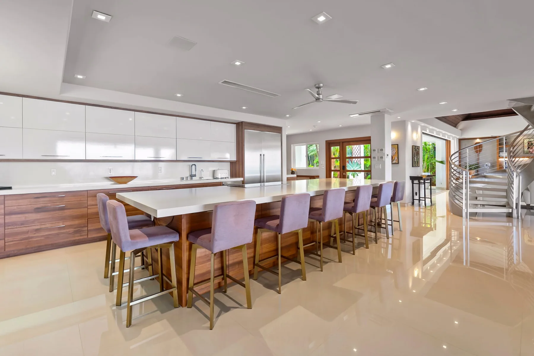 A spacious dining area with a long table and upholstered seating.