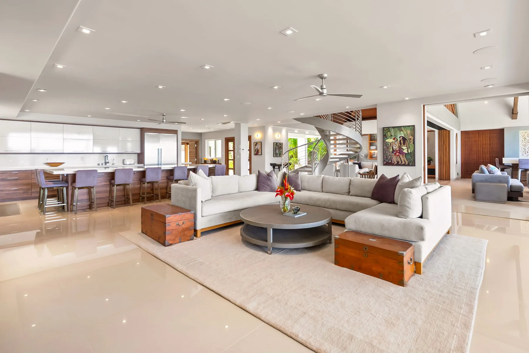 An open-plan living room with sectional seating and a dining area.