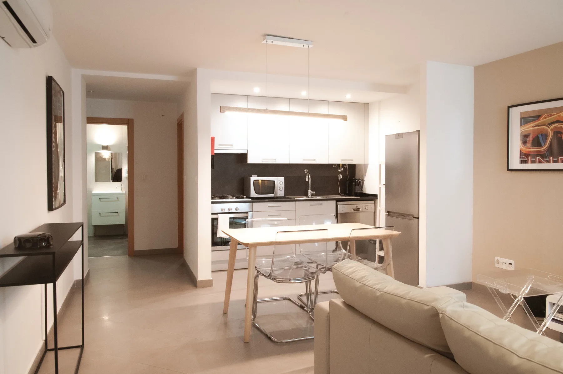 An open-plan kitchen and dining area with a table and seating.
