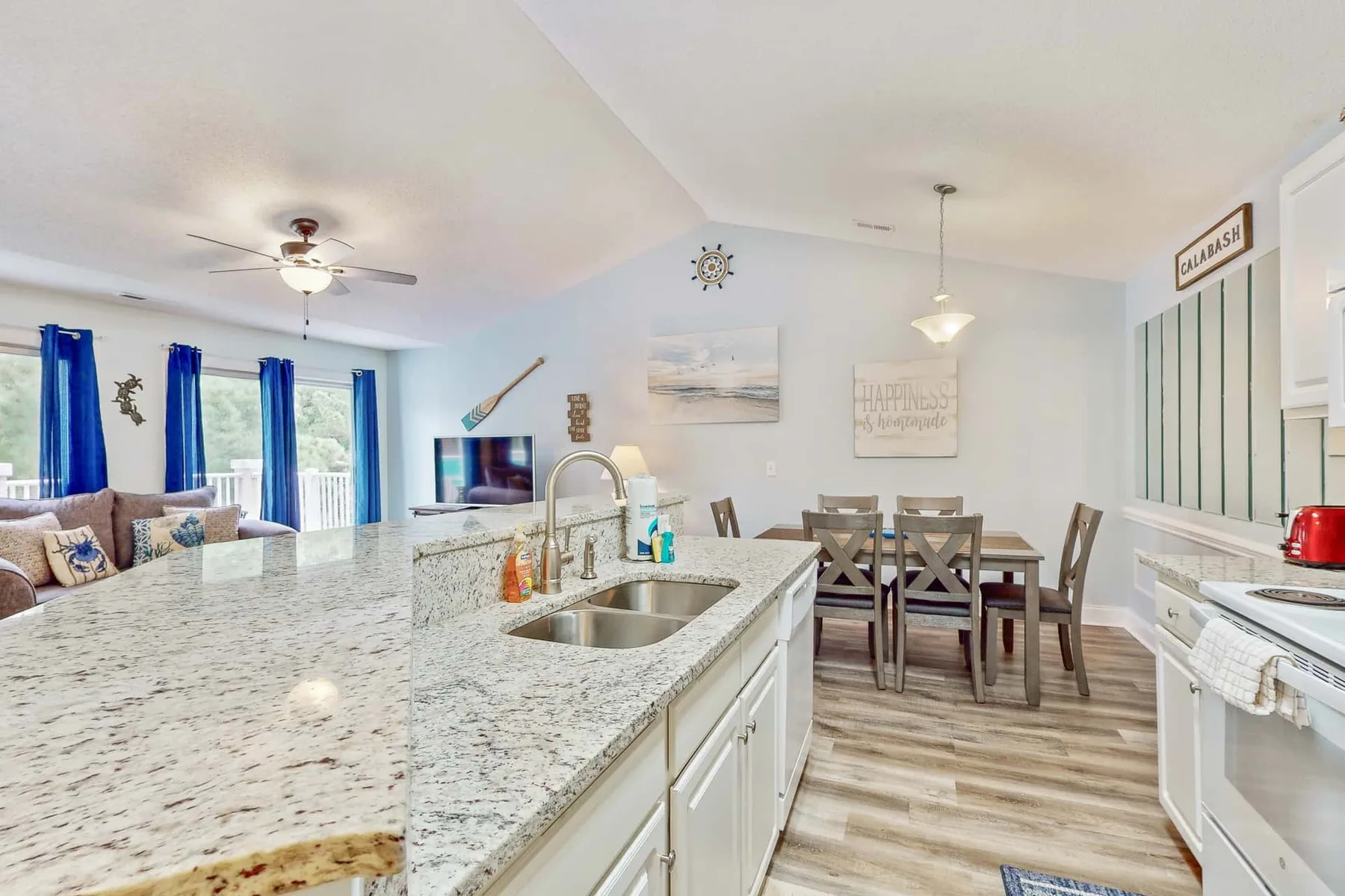 An open kitchen and dining area with a large island and a table.