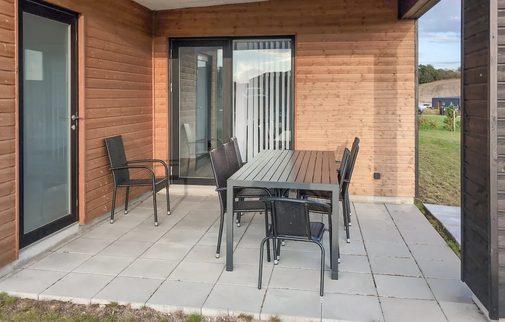 A covered patio with an outdoor dining table and seating.
