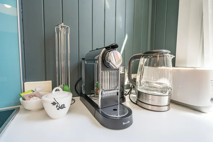 A kitchen counter with a coffee machine and electric kettle.