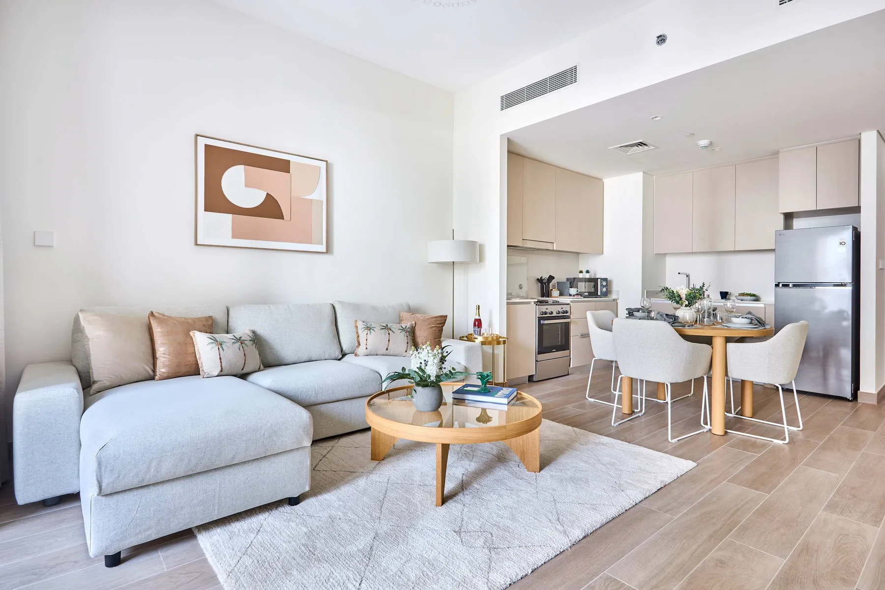 A bright living room opens into a kitchen and dining area.