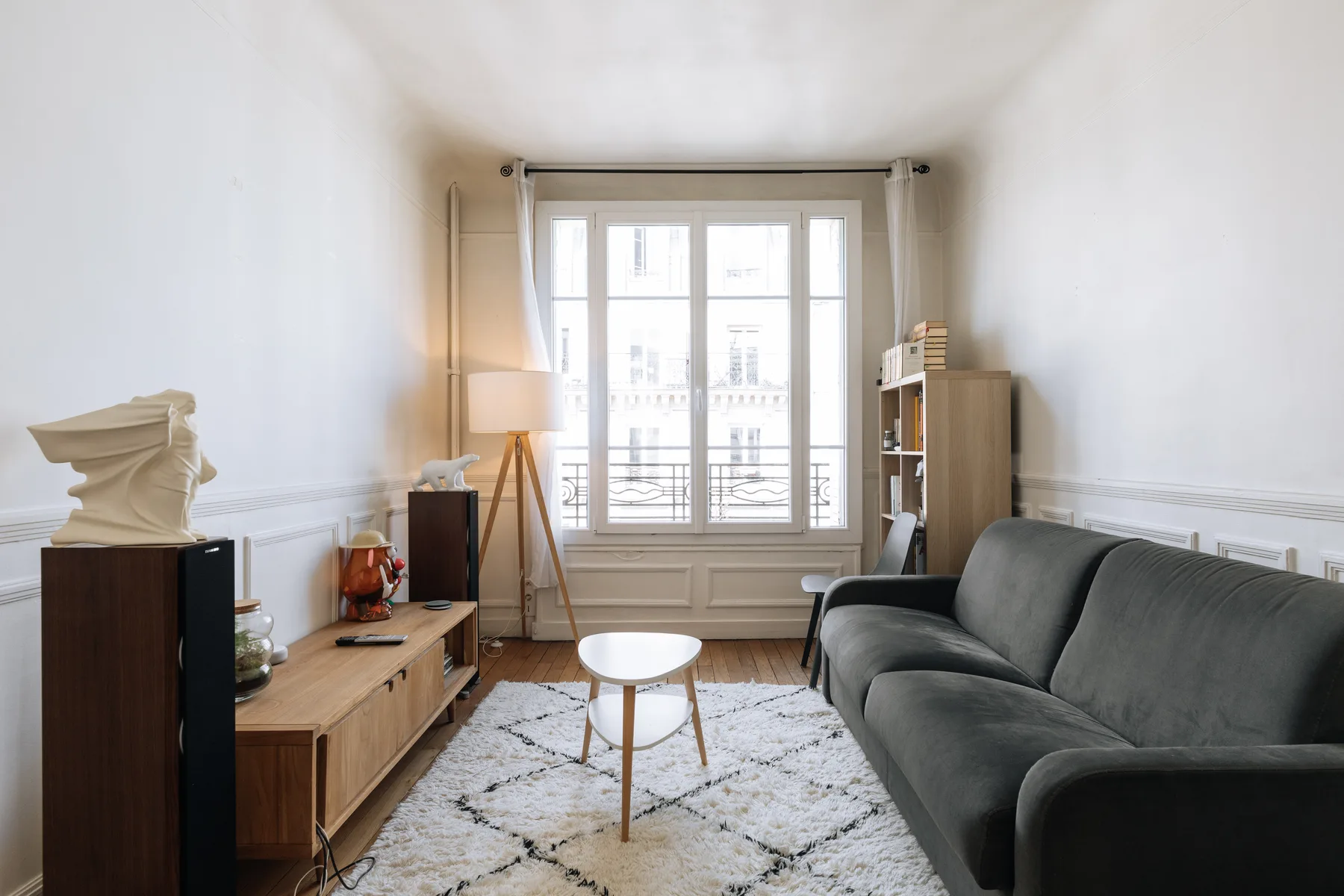 A bright living room with seating arranged around a small coffee table.
